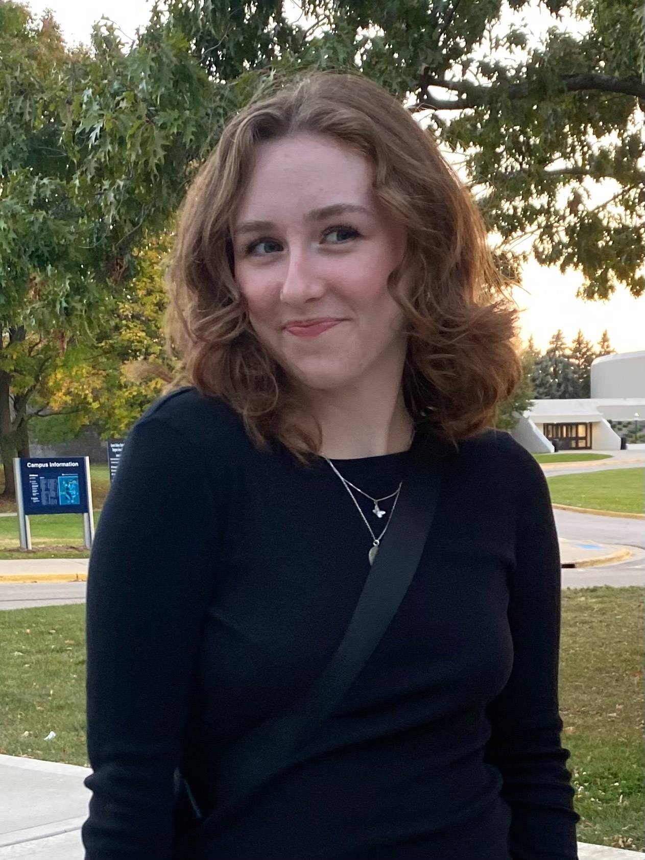 Bria Loveday smiling in front of a tree